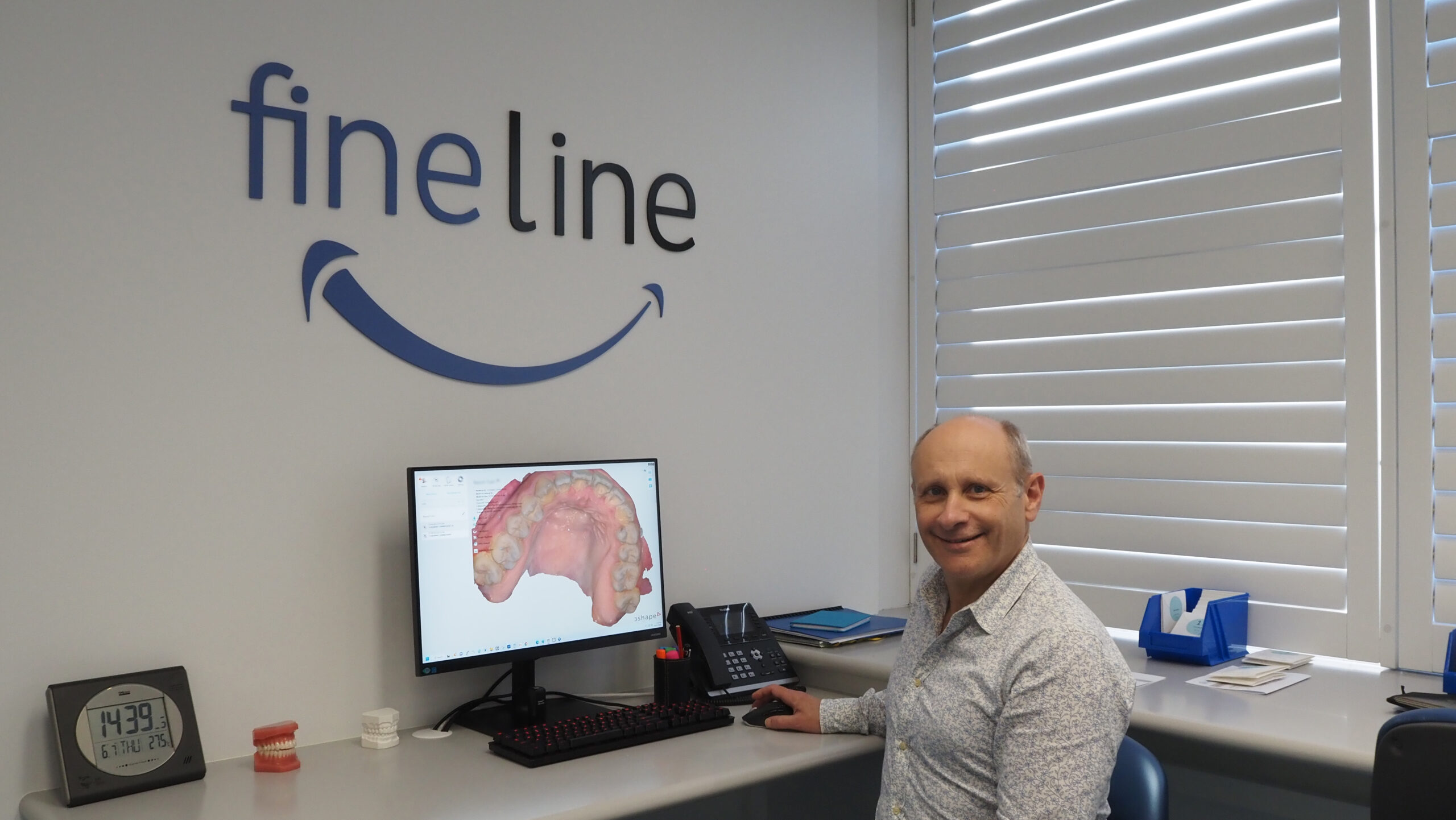 Dr Martin Fine at the Bondi Junction office doing orthodontic treatment planning on a computer.